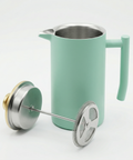 turquoise coffee tea press with stainless steel parts on a white background